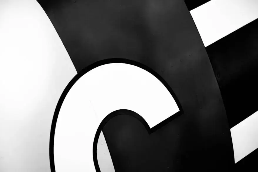 A black and white photo of a sign with the letter c.