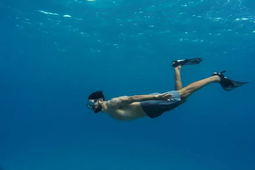 Decompression Sickness - man-freediving-with-flippers-underwater