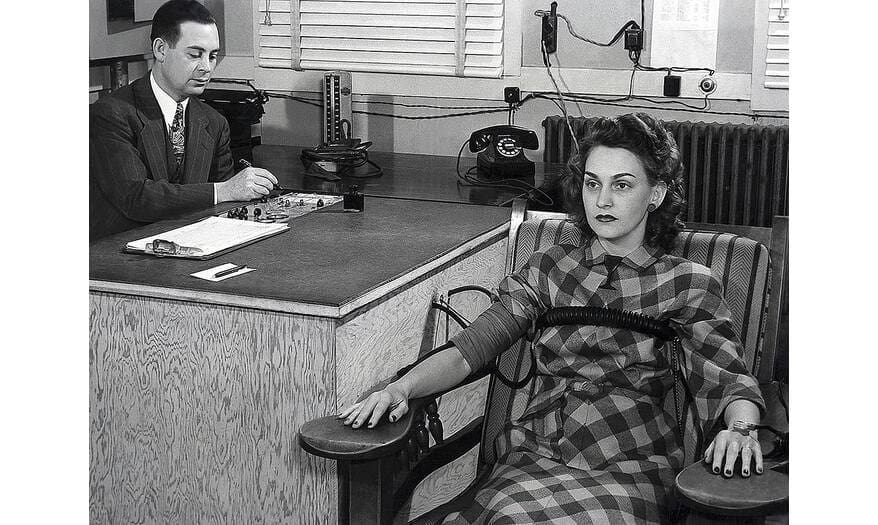 Lie detector test using a polygraph machine, Wikimedia Commons / public domain.