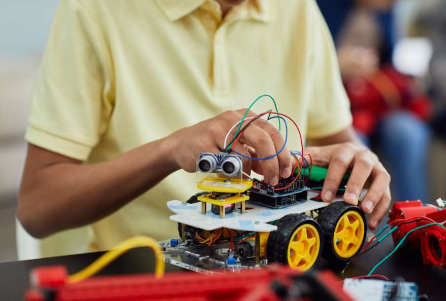 Boy playing with robotic toy car
